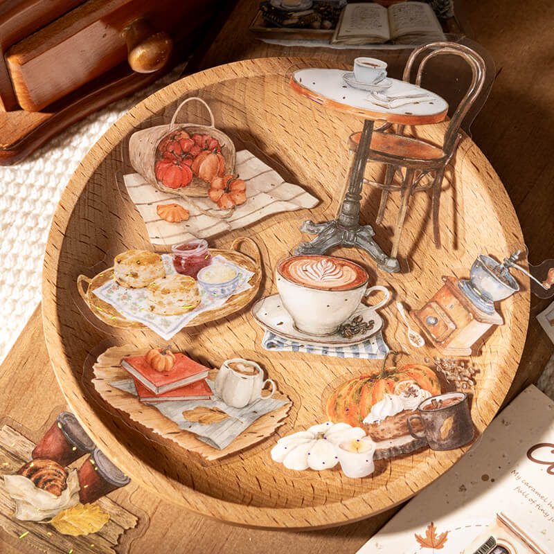 Autumncoffeeanddessertstickerswithalatte_coffeegrinder_cafetable_pumpkins_andpastries