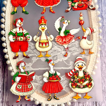 Christmasgoosestickerswithadrum_ornaments_redapples_afestivewreathandastorybook