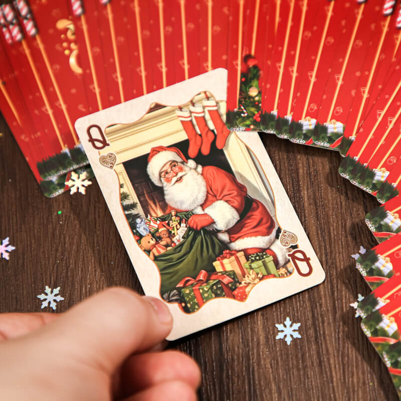 ChristmasqueencardfeaturingSantawithgifts_surroundedbyredcardbacks