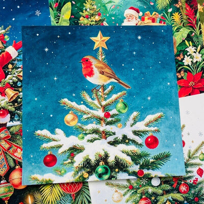 Christmasscrapbookpaperfeaturingarobinperchedonasnow-coveredtreewithcolorfulornamentsandagoldensta