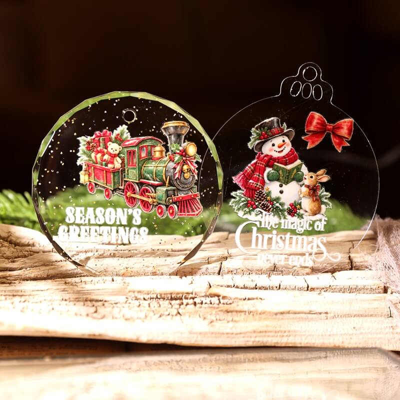 ClearChristmasornamentsdecoratedwithavintagetoytrain_asnowmanwitharabbit_andholidaygreetings