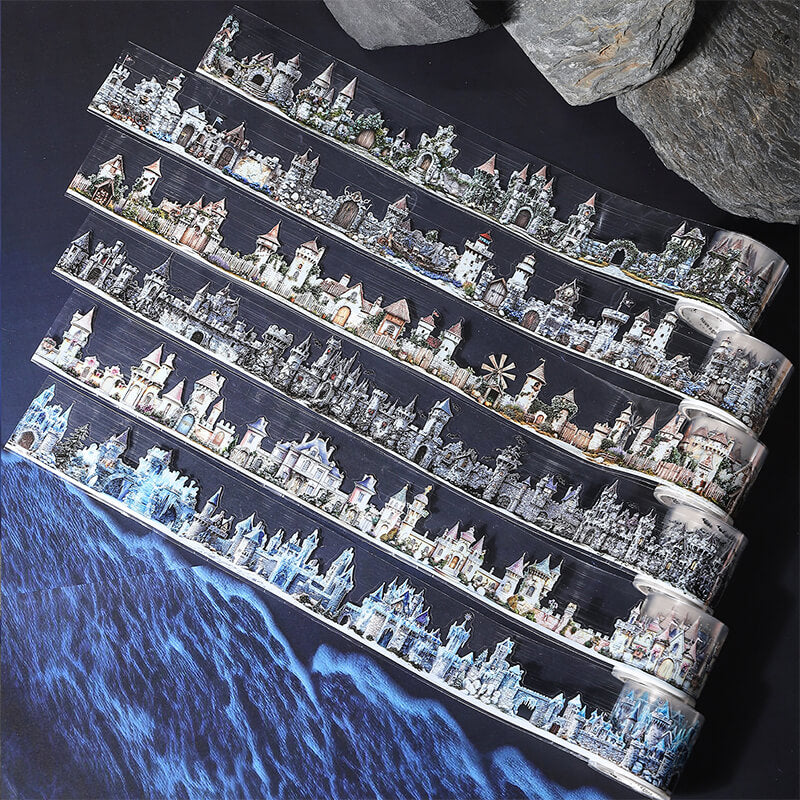 A long strip of decorative adhesive tape featuring a repeating fantasy castle and tower pattern, shown on a dark background with rocks and a blue icy ocean graphic.