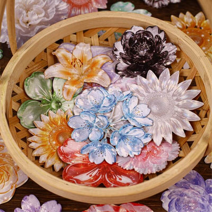 A collection of colorful, flower-shaped resin or ceramic pins arranged inside a round bamboo basket, with more flowers partially visible around the edges.