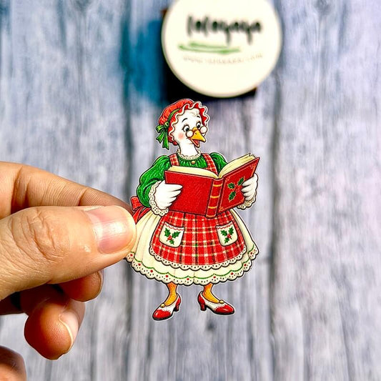HandholdingaChristmasgoosestickerwearingglassesandaredplaidapronwhilereadingaholly-decoratedbook