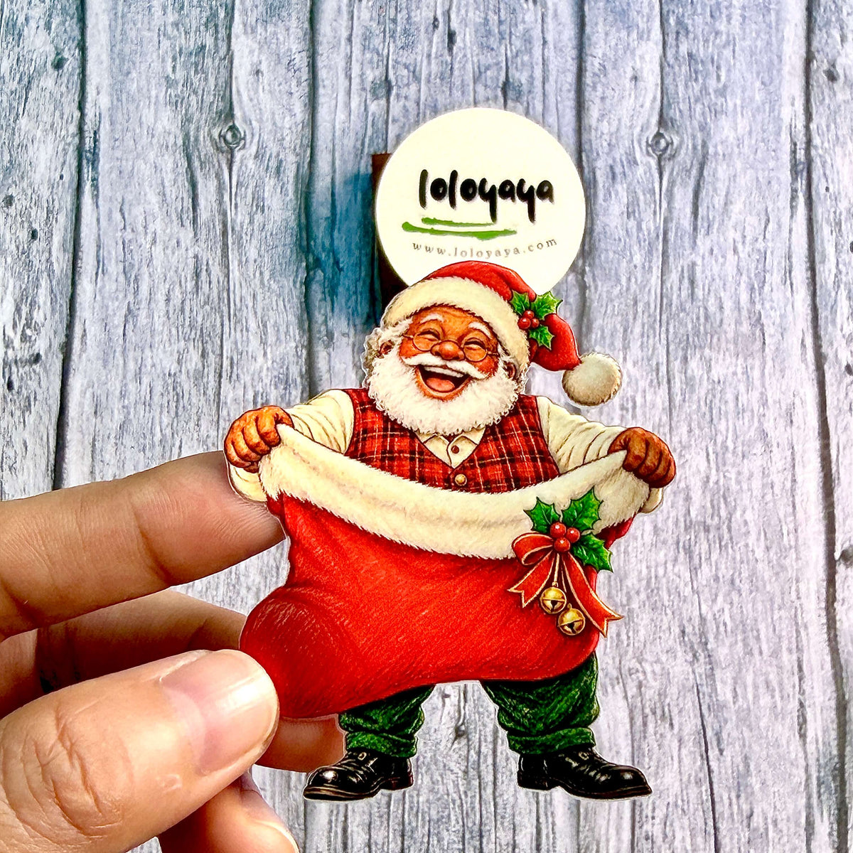 HandholdingasmilingSantaClausstickerwithanoversizedredChristmasstockingdecoratedwithhollyandbells