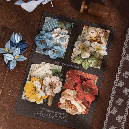 Black handmade card with four floral collages in blue, white, yellow and red.
