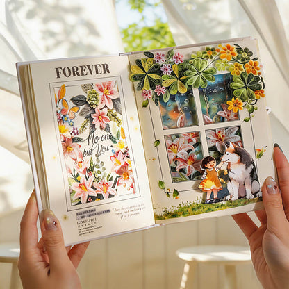 A person holds open a decorative scrapbook or art journal showing colorful floral illustrations and layered paper window scenes. The left page has the word "FOREVER" and a floral artwork with the phrase "No one but You.