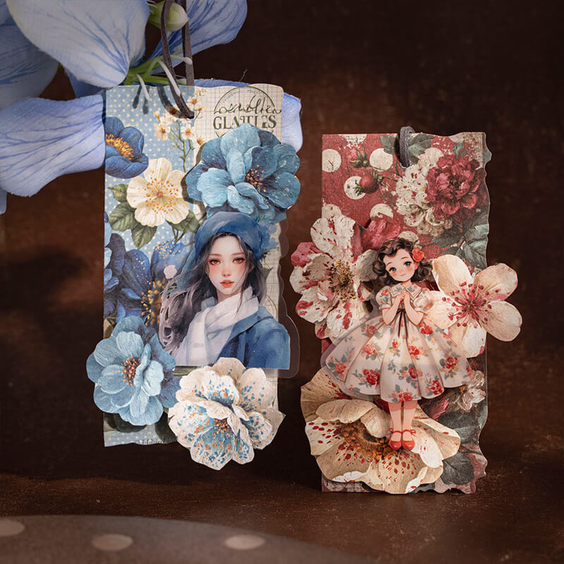 Twohandmadebookmarksdecoratedwithblueandredfloralcollagesandillustratedgirls