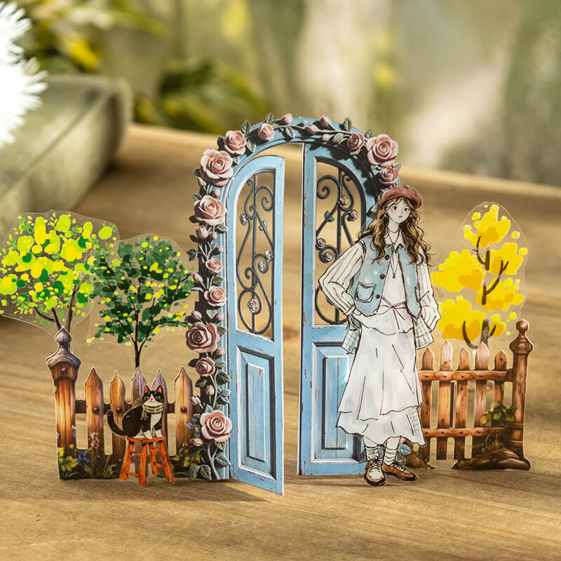 Vintagebluerose-coveredgardengatedisplayedwithawoman_cat_trees_andfencecutouts