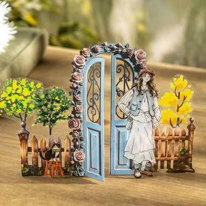 Vintagebluerose-coveredgardengatedisplayedwithawoman_cat_trees_andfencecutouts