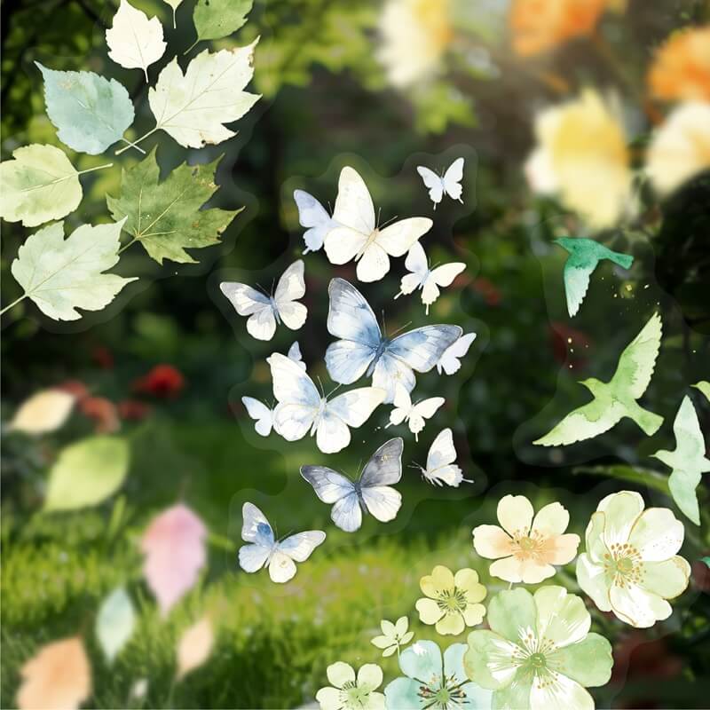 A sheet of decorative stickers featuring white and blue butterflies, green birds, and light green leaves, shown applied to a glass window with a blurred garden background.